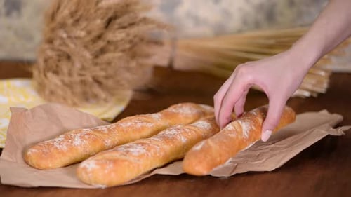 Fresh Baguettes on Paper with Wheat Bouquet