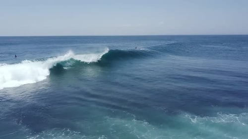 A Professional Male Surfer Riding the Intense Barrel of Waves in the Ocean
