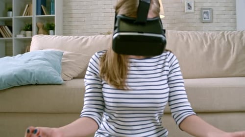 Woman Meditating with Virtual Reality Headset at Home