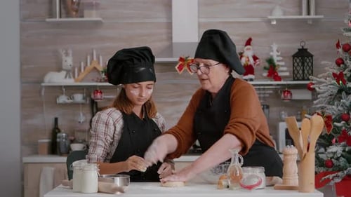 Grandmother and Granddaughter Baking Holiday Cookies Together