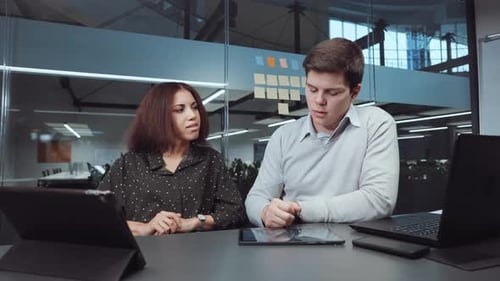 Multiethnic Business Analysts Checking Tablet in Office