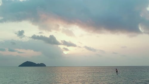 Paddle Boarding in the Ocean at Sunset