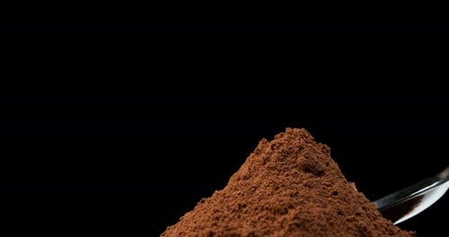Nutmeg, myristica fragans, Powder falling against Black Background, Slow Motion 4K