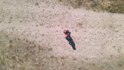 Aerial top down view of Woman runs trail running marathon in a countryside road, slow motion 60 fps