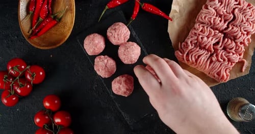 Raw Meatballs, Red Peppers, and Cherry Tomatoes