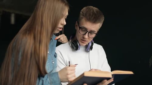 Two Students Studying from a Book Together