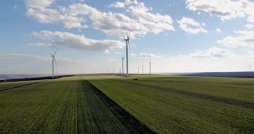 Scenery Of Windmill Turbines In Green Meadows During Summertime. - Aerial Drone Shot