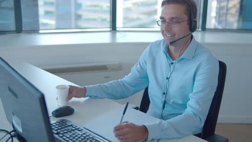 Positive Male Operator Headset Taking Call