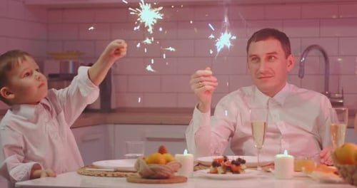 Festive Family Holding Sparklers in Warm Kitchen