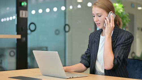 Young Adult Woman Working at Office Desk