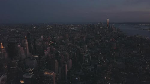 AERIAL: Manhattan Drone Flight at Night with Glowing City Light in New York City