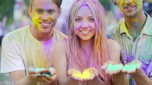 Friends Celebrate Holi Blowing Colorful Powders