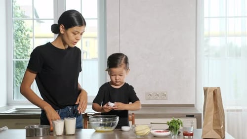 Mother Controls Kid Mixing Prepared Before Salt and Sugar