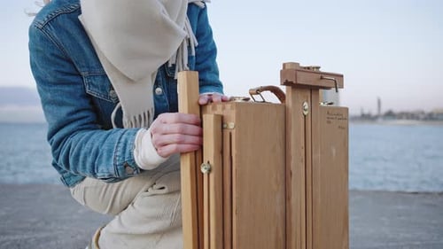 Artist Sets up Easel on Boardwalk by the Sea
