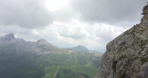 Aerial drone view of a man and woman couple hiking in the mountains.