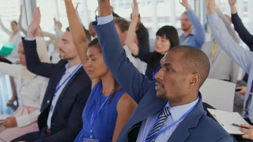 Business People Raising Hands at an Event