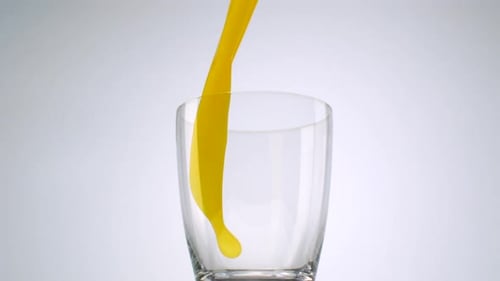 Orangensaft in Glas gießen, Zeitlupe