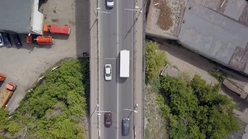 Straight Top View on Bridge Over River with Moving Cars in Summer Day