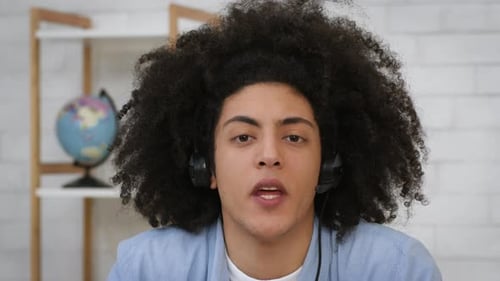 Young Adult with Headset Speaking to Camera