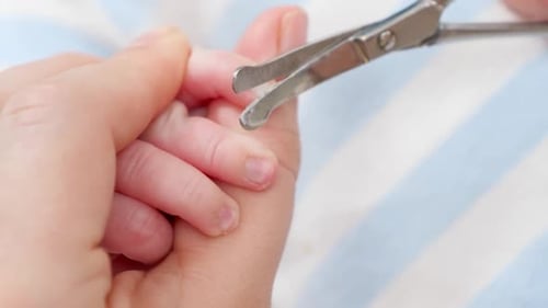 Adult Trimming Infant Fingernails with Small Clippers