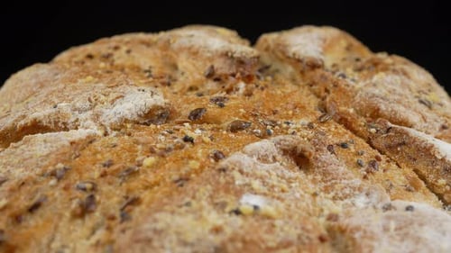 Seeded Bread Rotating on Black Background Close Up