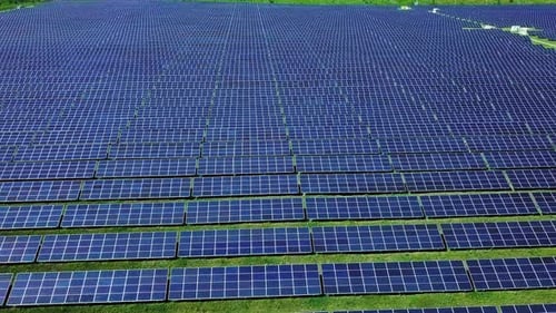 Large Field Of Blue Photovoltaic Solar Panels. Aerial View. Flying Sideways To The Right.