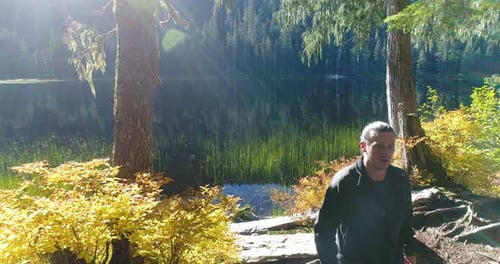 Man And Puppy Hiking Trail in Pacific Northwest Forest Lake