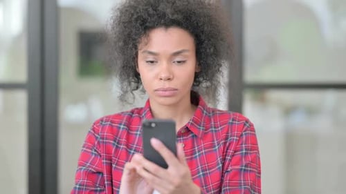Woman Reacting to Content on Mobile Phone
