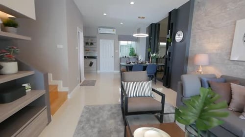 Sala de estar totalmente decorada con muebles e iluminación elegantes