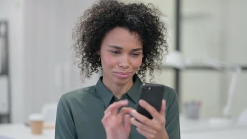 Woman Smiling While Using Phone