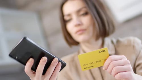 Woman Using Smartphone for Online Payment with Credit Card