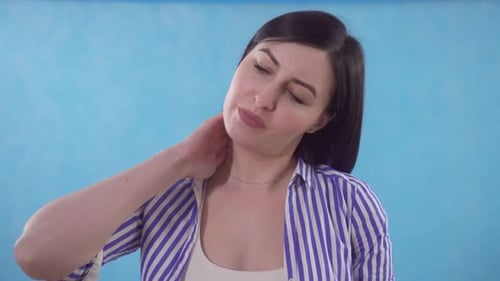 Woman Rubbing Her Neck in Discomfort
