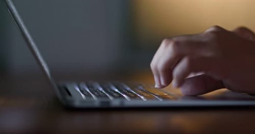 Type on laptop computer at night