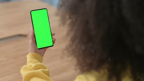 African Businesswoman Using Smartphone with Green Chroma Key Screen