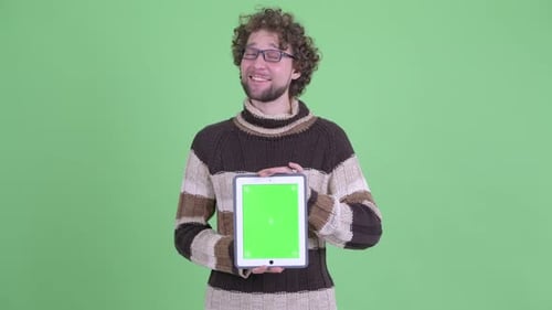 Man Presents Tablet with Chroma Key Screen