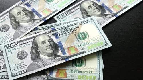 Falling Hundred Dollar Bills Pile Up
