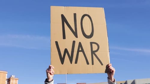 People on the Street PROTEST Against WAR Woman Holding Banner