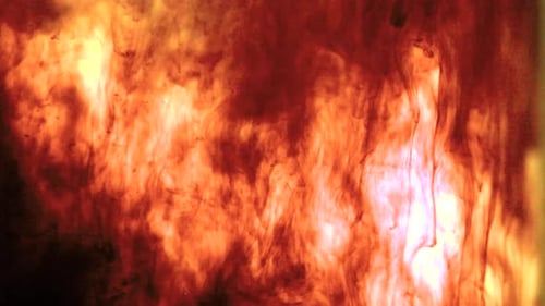 Fiery Orange Ink Plumes Flowing Abstractly in Water