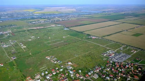 View Through the Airplane Window of the City and the Rooftops
