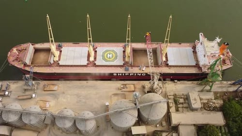 Loading Grain Into Sea Cargo Vessel in Seaport From Silos of Grain Storage