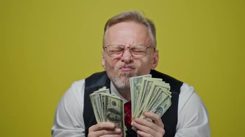 Man Holding Wads of Cash, Sticking Tongue Out