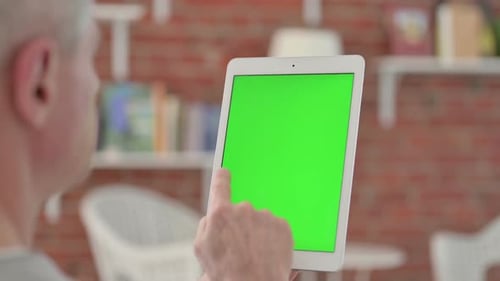 Adult Using Tablet with Green Screen