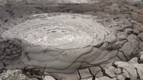 Bubbling Mud Pot in Geothermal Landscape