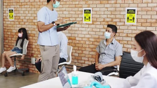People Waiting in Medical Waiting Room Wearing Masks