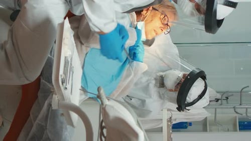 Dentist and Assistant Attending to Patient