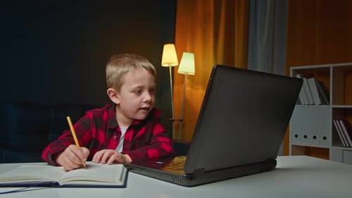 Preschooler Boy Making Online School Homework Using Laptop