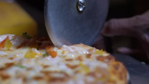 Cutting Fresh Pizza with a Rotary Pizza Cutter