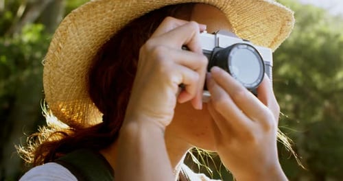 Woman Taking Pictures in a Green Forest