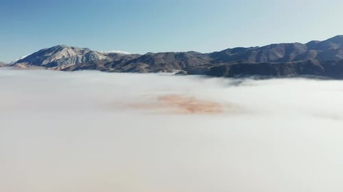 Beautiful Aerial View Over the Death Valley Covered By Fog Clouds at Sunrise