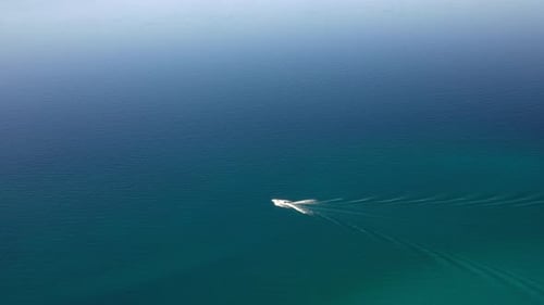 Aerial View Of Speedboat Cruising In The Calm Blue Waters.